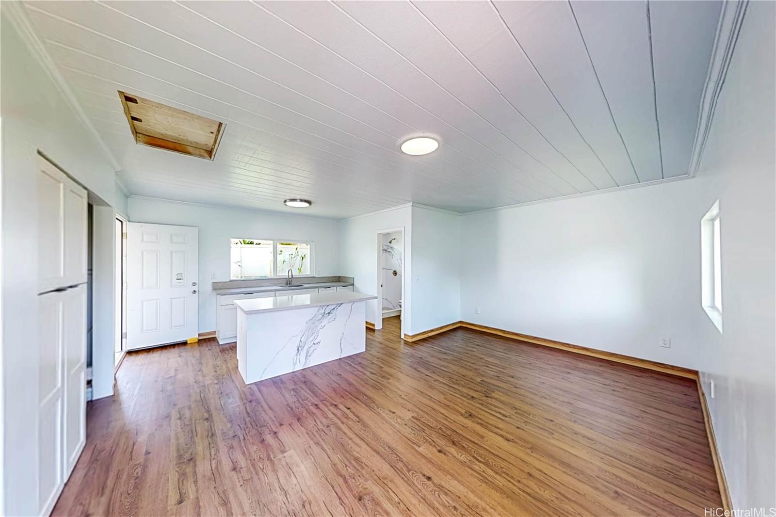 1543 Mahie Place Honolulu, HI 96818 - Photo 11 of 25 a view of empty room with wooden floor and kitchen
