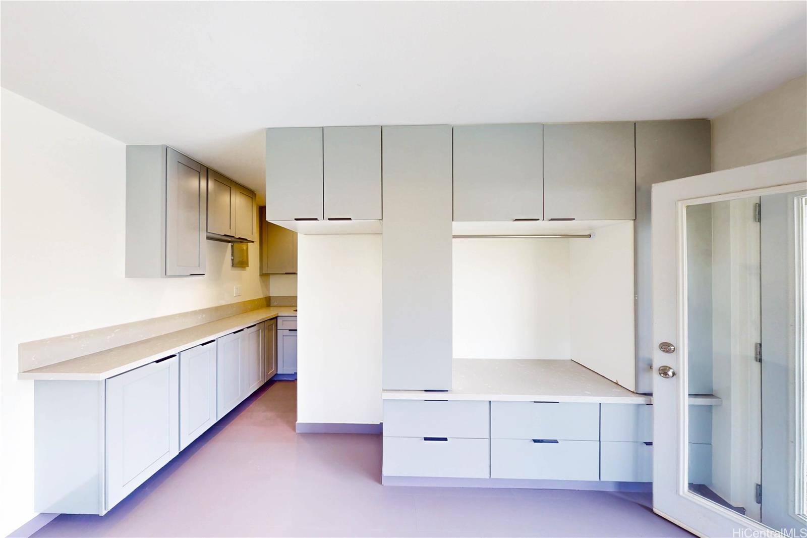 1543 Mahie Place Honolulu, HI 96818 - Photo 18 of 25 a kitchen with white cabinets and window