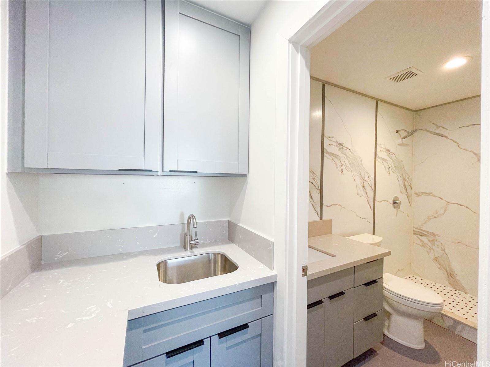 1543 Mahie Place Honolulu, HI 96818 - Photo 20 of 25 a bathroom with a sink toilet vanity and tub