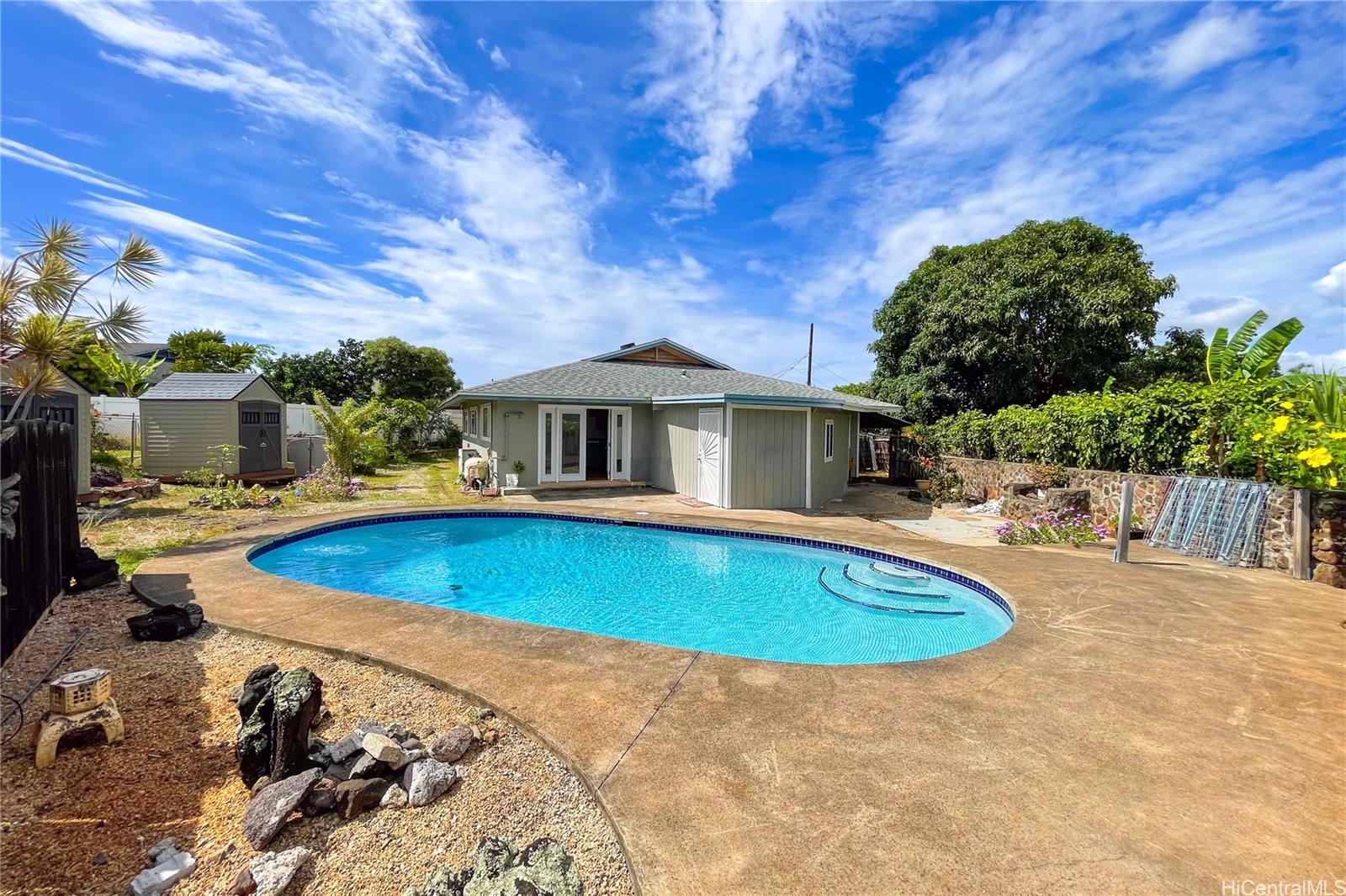 1543 Mahie Place Honolulu, HI 96818 - Photo 2 of 25 a view of a house with swimming pool and sitting area