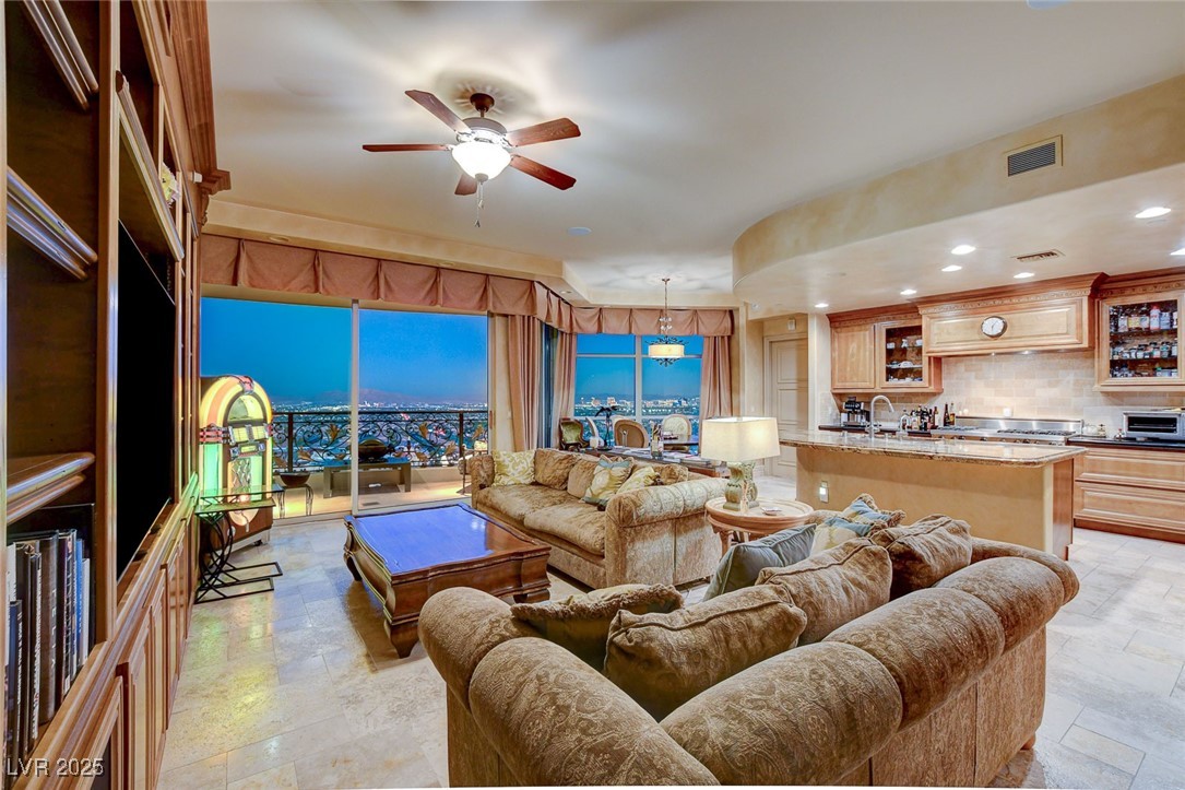 9101 Alta Drive, Unit 1406 Las Vegas, NV 89145 - Photo 2 of 69 Living area with recessed lighting, a ceiling fan, and light stone finish floors