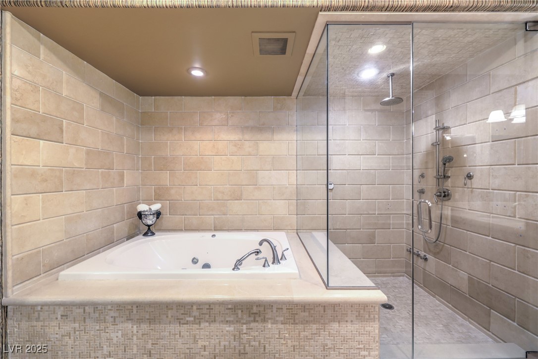 9101 Alta Drive, Unit 1406 Las Vegas, NV 89145 - Photo 35 of 69 Full bath with a whirlpool tub, tile walls, a stall shower, and recessed lighting