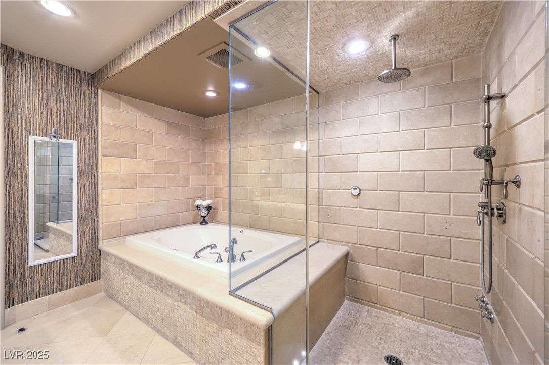 9101 Alta Drive, Unit 1406 Las Vegas, NV 89145 - Photo 36 of 69 Full bath featuring a garden tub, a stall shower, tile walls, recessed lighting, and tile patterned flooring