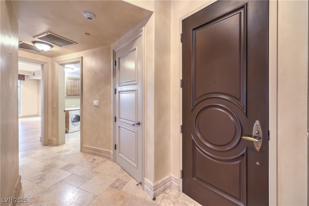 9101 Alta Drive, Unit 1406 Las Vegas, NV 89145 - Photo 39 of 69 Hallway with stone tile floors and washer / clothes dryer
