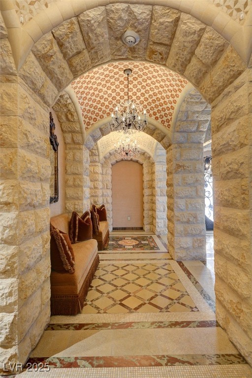 9101 Alta Drive, Unit 1406 Las Vegas, NV 89145 - Photo 69 of 69 Wine area featuring a chandelier, inlaid floor details, and lofted ceiling