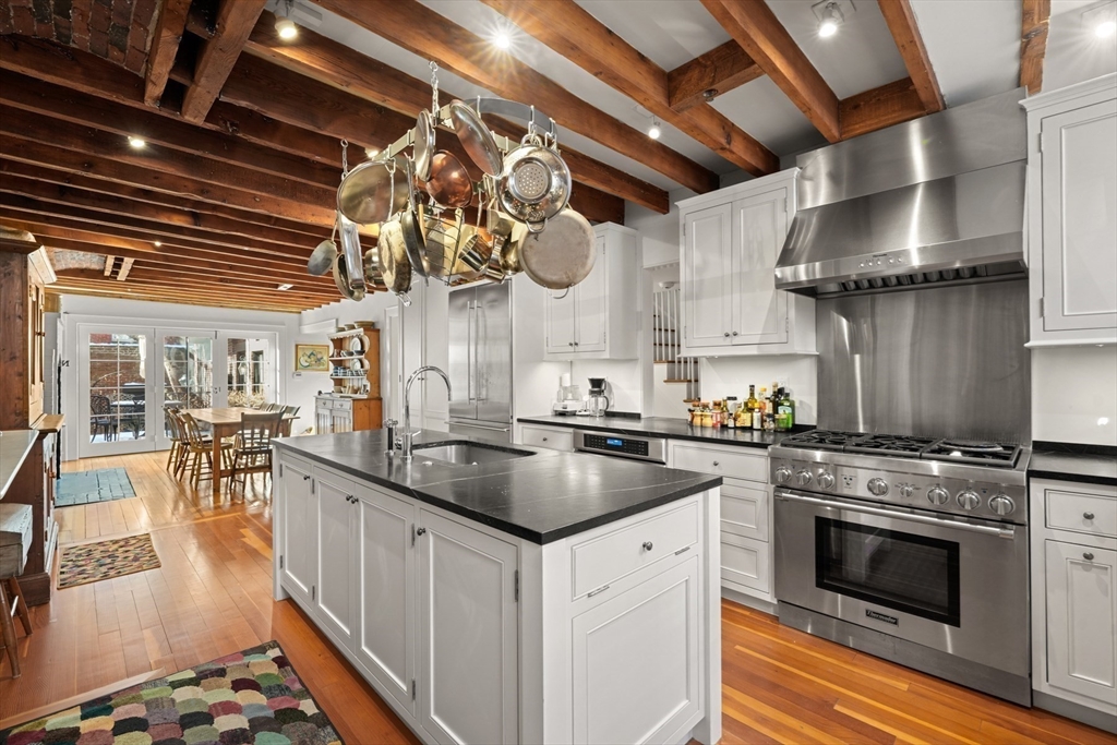 32 West Cedar Street Boston, MA 02108 - Photo 13 of 39 a kitchen with stainless steel appliances granite countertop a large stove a sink and a microwave