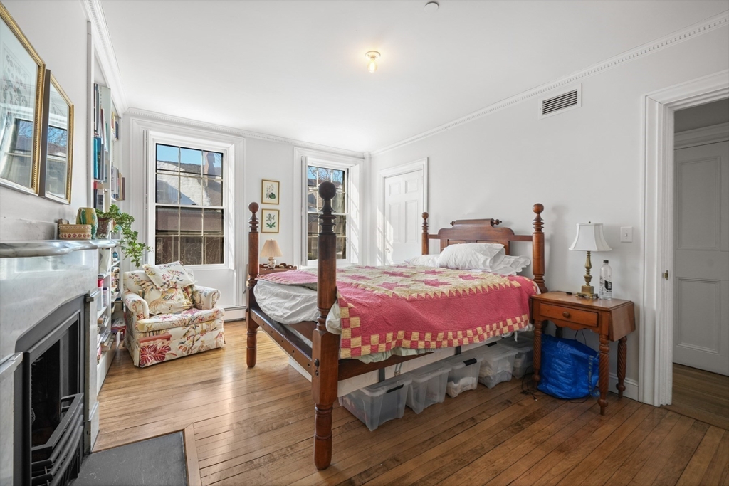 32 West Cedar Street Boston, MA 02108 - Photo 19 of 39 a bedroom with a bed and wooden floor