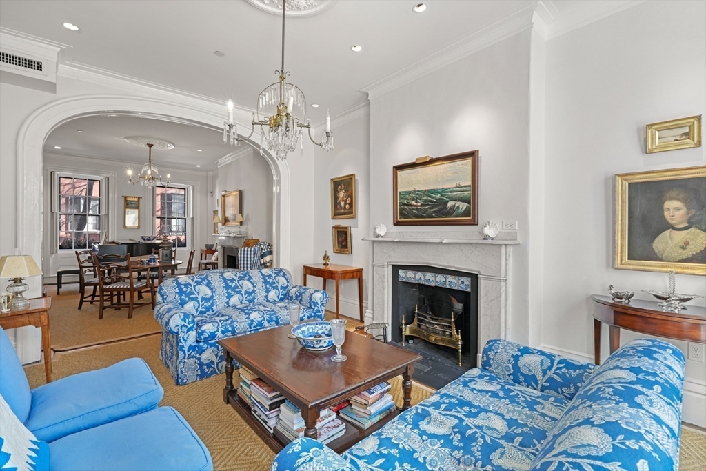 32 West Cedar Street Boston, MA 02108 - Photo 2 of 39 a living room with furniture a chandelier and a fireplace