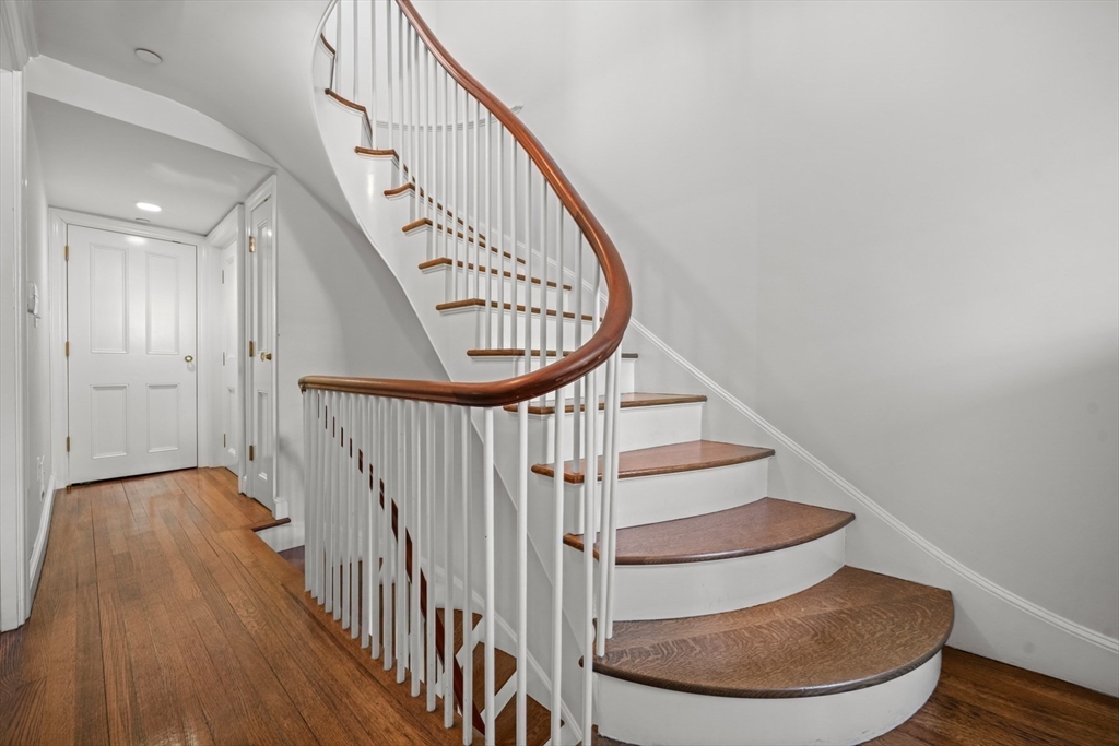 32 West Cedar Street Boston, MA 02108 - Photo 22 of 39 a view of staircase with wooden floor and a front door