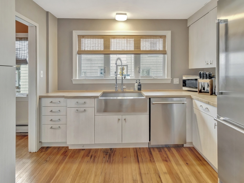48 A B Street Hull, MA 02045 - Photo 3 of 41 a kitchen with sink cabinets and window