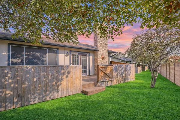 a view of house with backyard