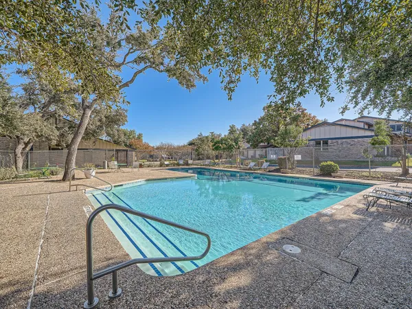 a view of a swimming pool with a yard