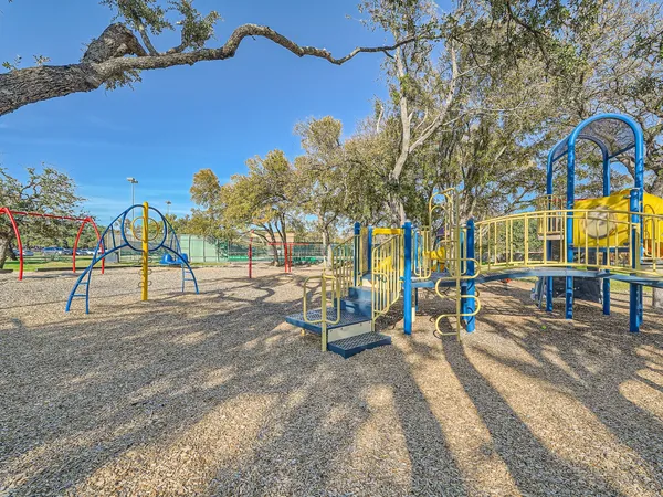 a view of a park with swings and slides