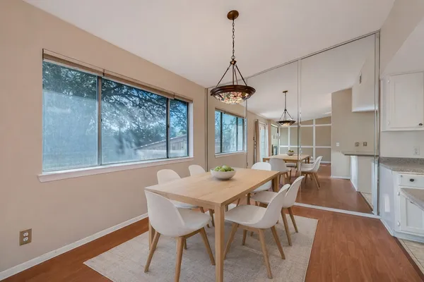 a view of a dining room with furniture window and wooden floor