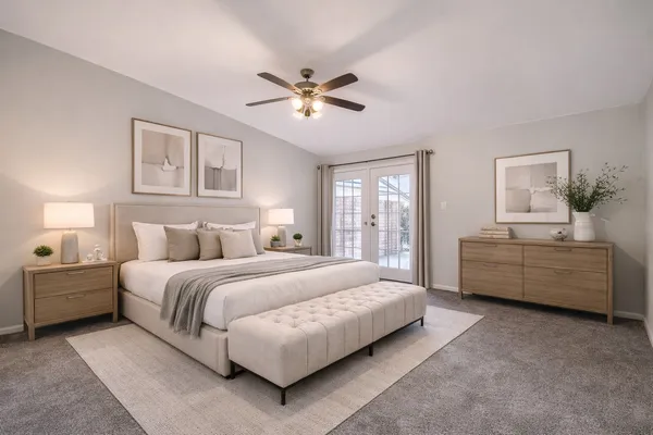 a bedroom with a bed and a chandelier