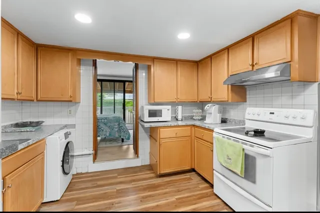 a kitchen with a stove top oven sink and cabinets