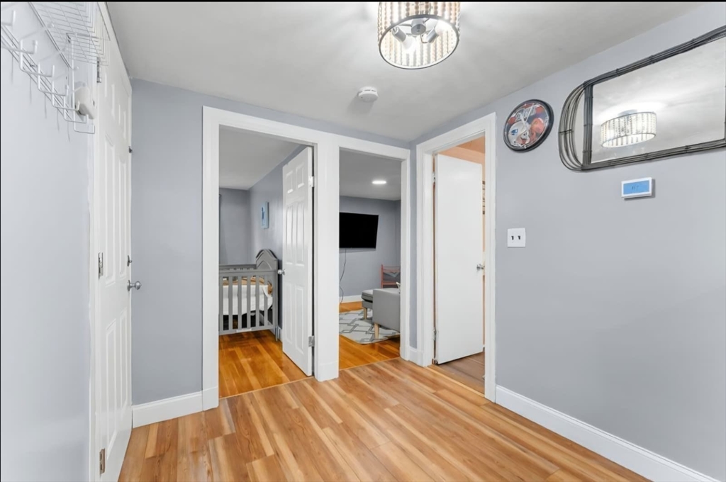 44 Woodlawn Avenue, Unit 2 Everett, MA 02149 - Photo 13 of 18 a view of a hallway with wooden floor