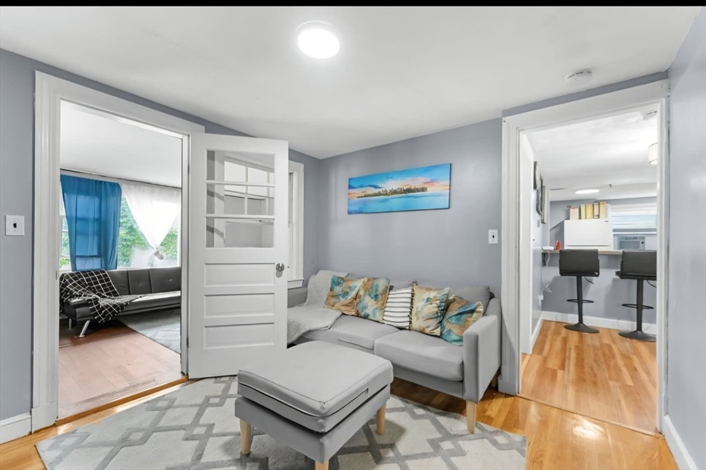 44 Woodlawn Avenue, Unit 2 Everett, MA 02149 - Photo 14 of 18 a living room with furniture and a table