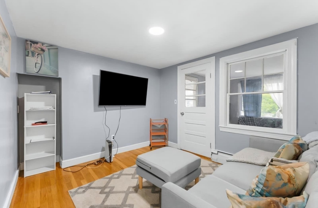 44 Woodlawn Avenue, Unit 2 Everett, MA 02149 - Photo 15 of 18 a living room with furniture and a flat screen tv
