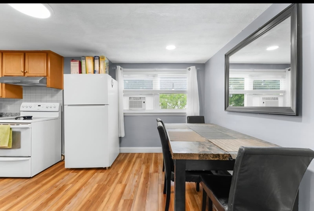 44 Woodlawn Avenue, Unit 2 Everett, MA 02149 - Photo 5 of 18 a kitchen with a table and chairs