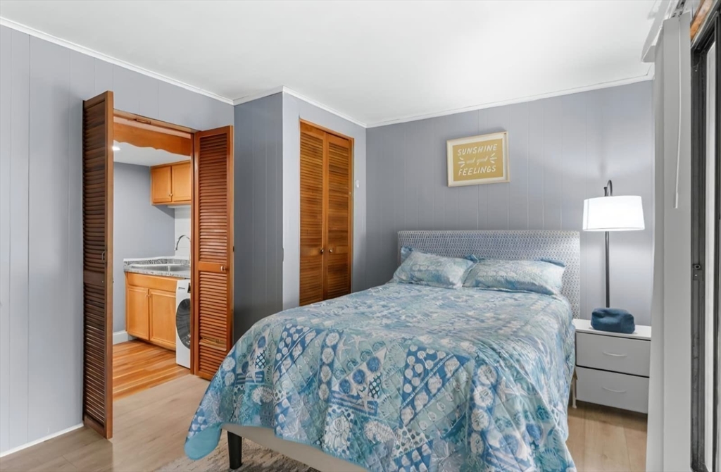 44 Woodlawn Avenue, Unit 2 Everett, MA 02149 - Photo 7 of 18 a bedroom with a bed and a lamp with window