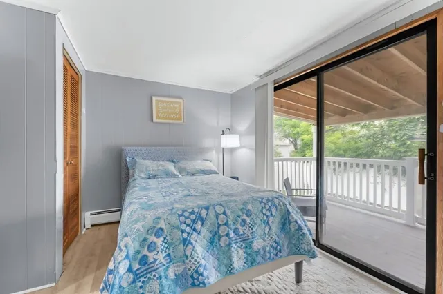 a bedroom with a bed and a large window with outer view