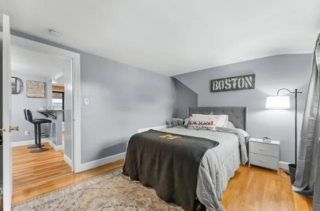 a bedroom with a bed and a view of en suite bathroom