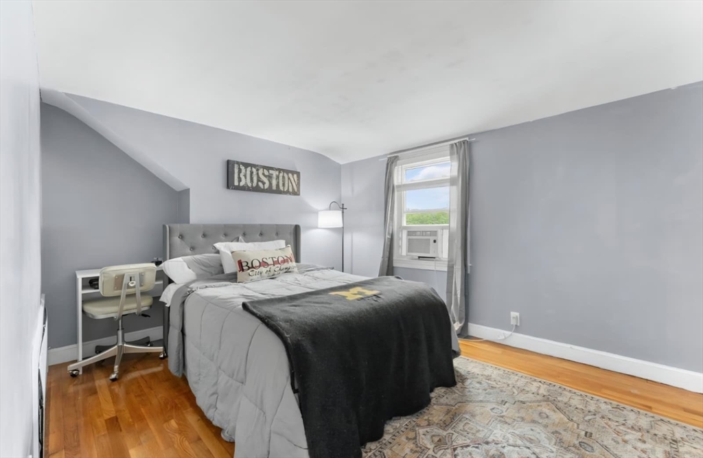 44 Woodlawn Avenue, Unit 2 Everett, MA 02149 - Photo 10 of 18 a bedroom with a bed and a window