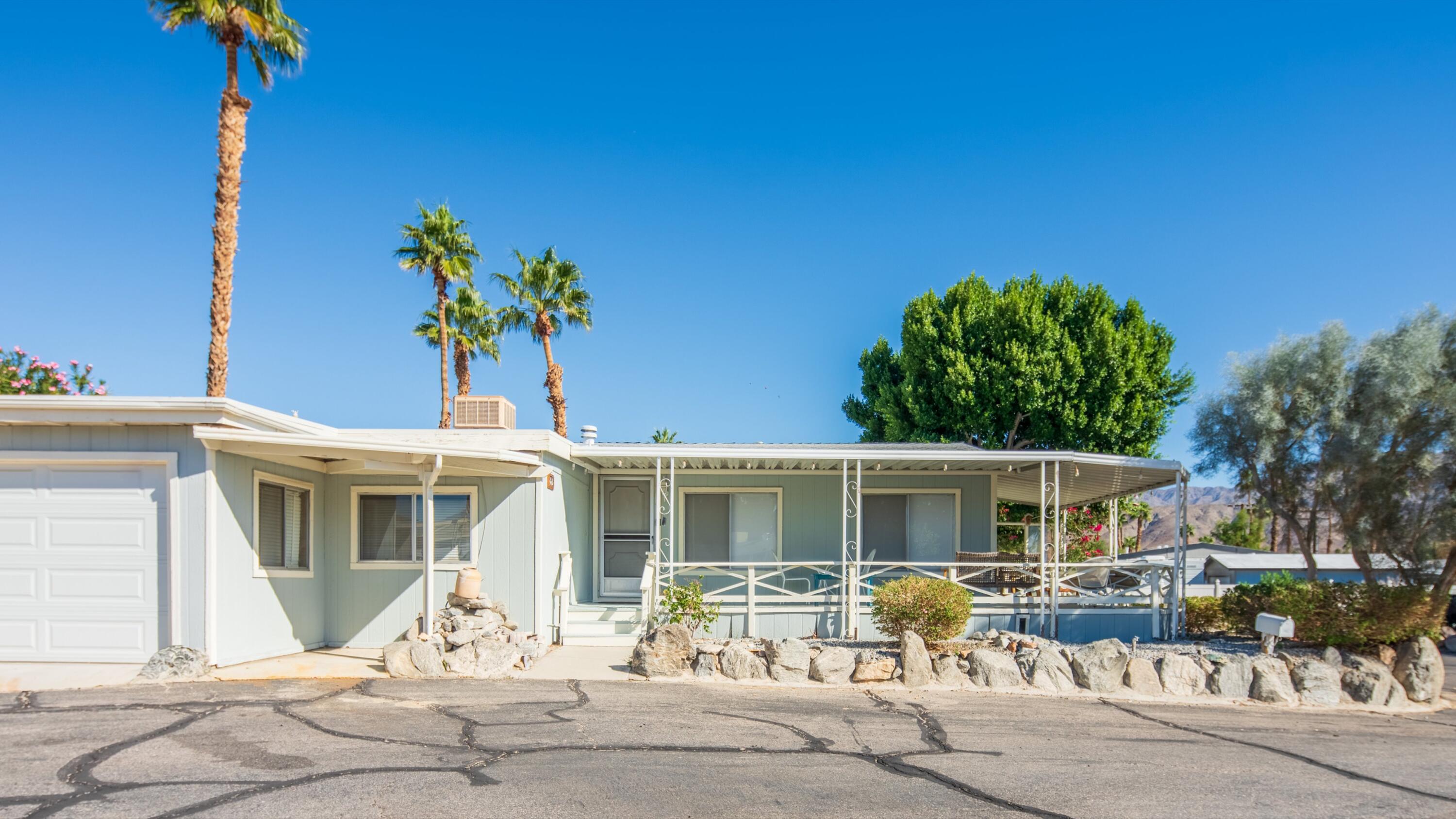 74711 Dillon Road, Unit 392 Desert Hot Springs, CA 92241 - Photo 29 of 46 a front view of a house with patio