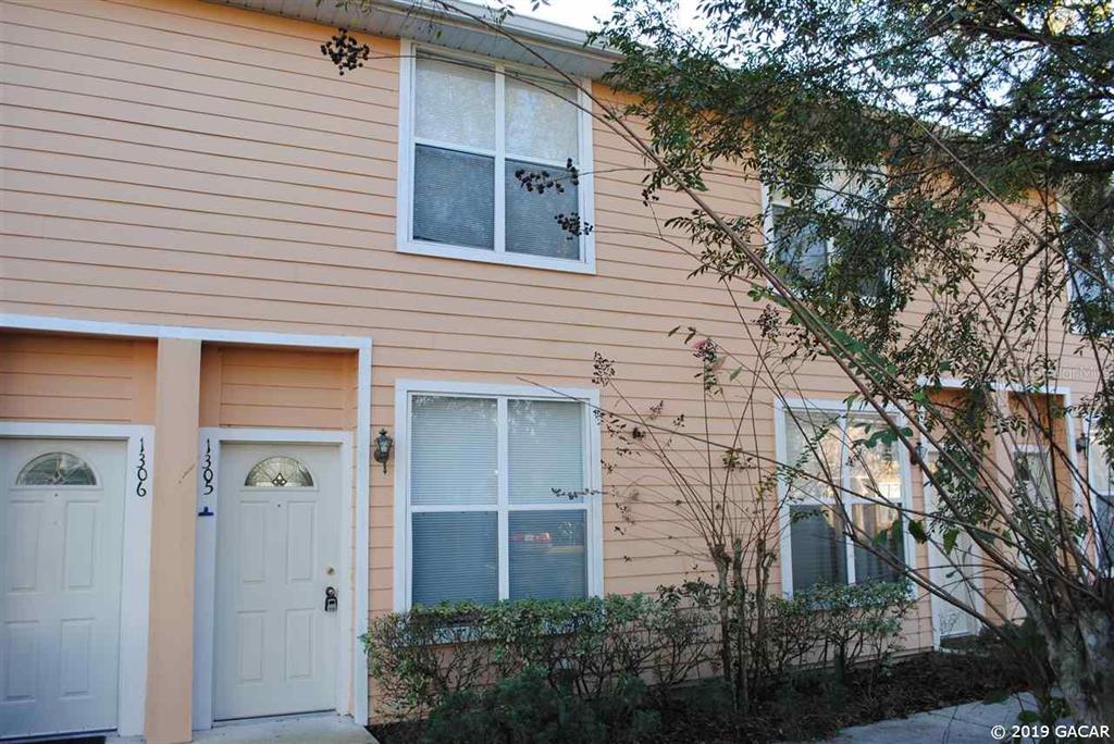 3920 Southwest 20th Avenue, Unit 1305 Gainesville, FL 32607 - Photo 1 of 1 a view of a house with a yard and garage