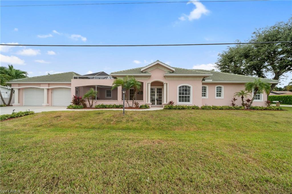 a front view of a house with a garden