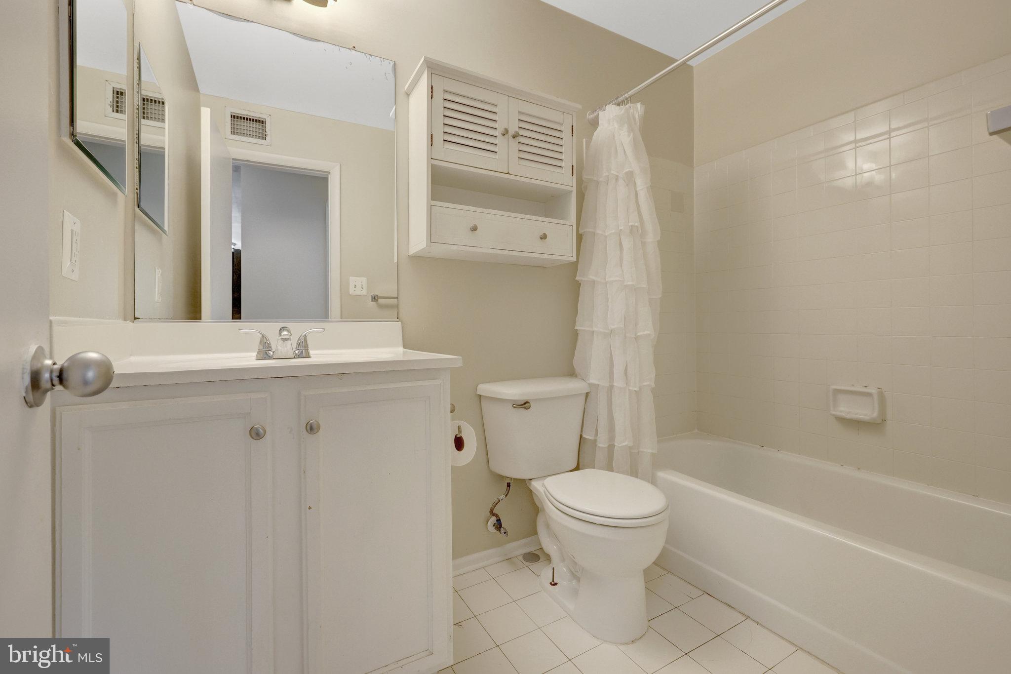 1791 Jonathan Way, Unit 1791B Reston, VA 20190 - Photo 12 of 27 a bathroom with a sink a toilet a mirror and shower
