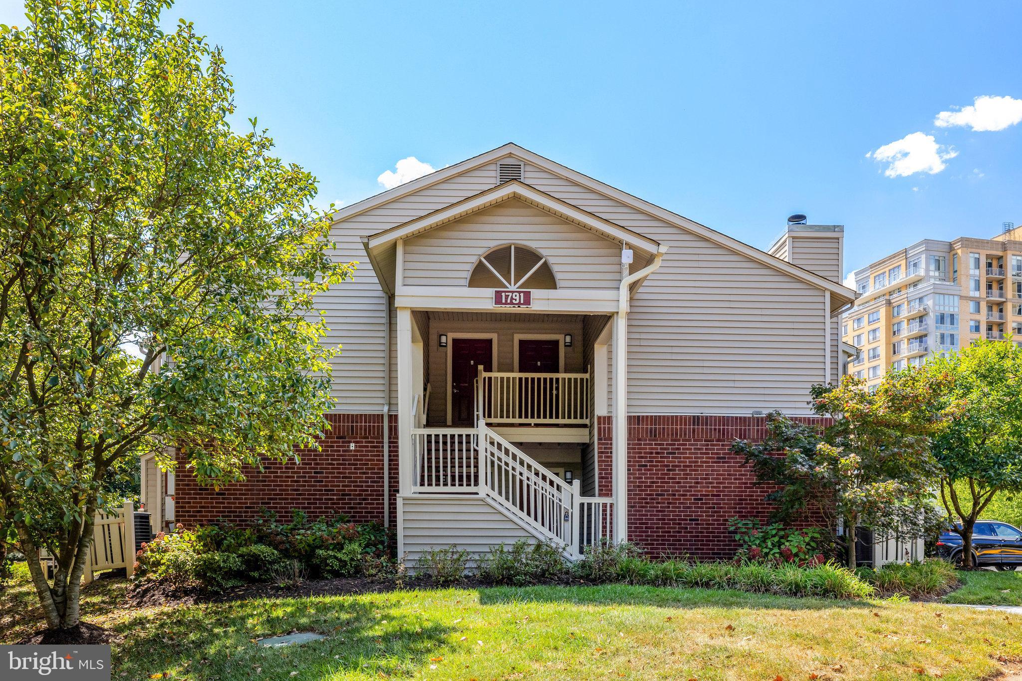 1791 Jonathan Way, Unit 1791B Reston, VA 20190 - Photo 17 of 27 a front view of a house with a yard and garage