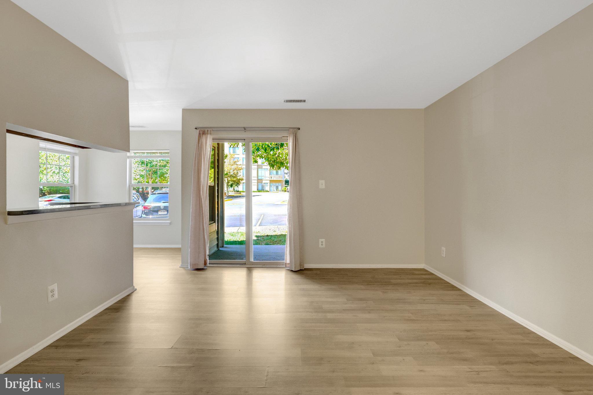 1791 Jonathan Way, Unit 1791B Reston, VA 20190 - Photo 3 of 27 wooden floor in an empty room with a window