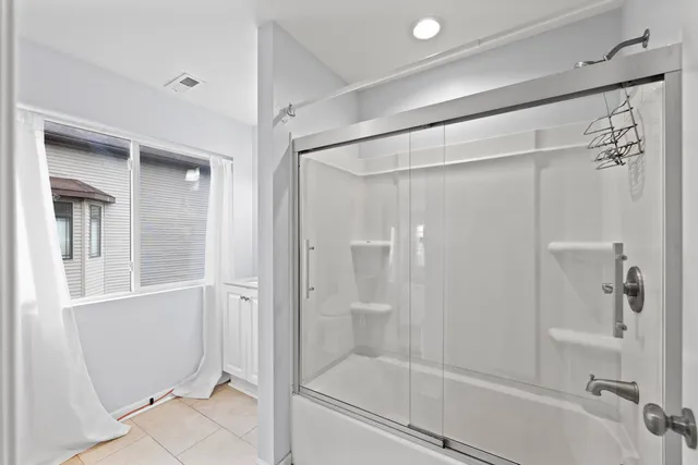a bathroom with a glass shower door