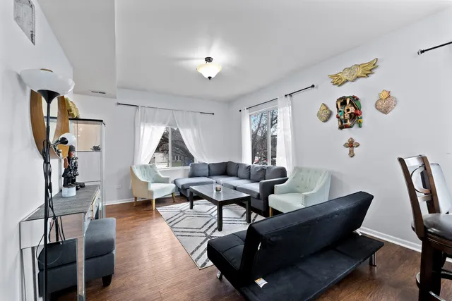 a living room with furniture a rug and gym equipment