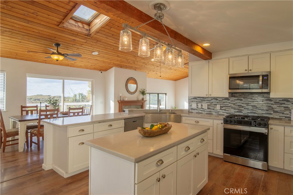 38340 Carrillo Road Fallbrook, CA 92028 - Photo 8 of 33 a kitchen with a stove a sink and a refrigerator