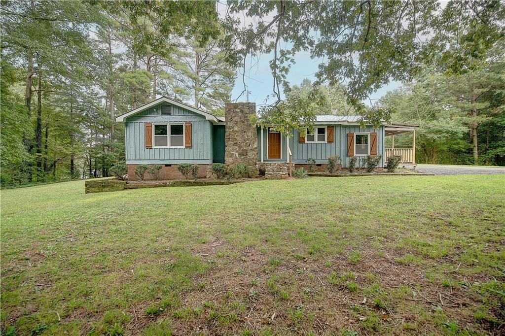 1638 Artesian Well Road Northwest Calhoun, GA 30701 - Photo 1 of 1 a front view of house with yard and trees