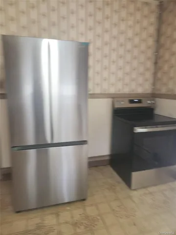 a kitchen with a refrigerator and a stove