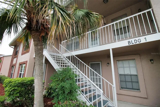 a balcony with table and stairs