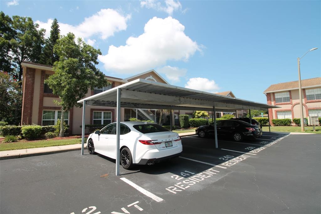 6338 Spring Flower Drive, Unit 21 New Port Richey, FL 34653 - Photo 12 of 18 a view of a patio with table and chairs and potted plants