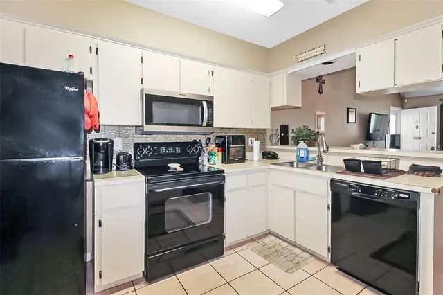 a kitchen with cabinets stainless steel appliances and a counter space