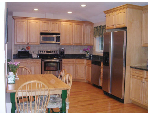 32 Squire Road Winchester, MA 01890 - Photo 4 of 6 a kitchen with stainless steel appliances granite countertop a refrigerator a stove top oven a sink and dishwasher