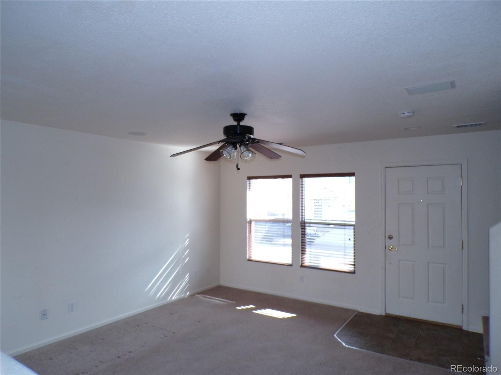 Undisclosed Address Morrison, CO 80465 - Photo 6 of 20 an empty room with a window and a ceiling fan