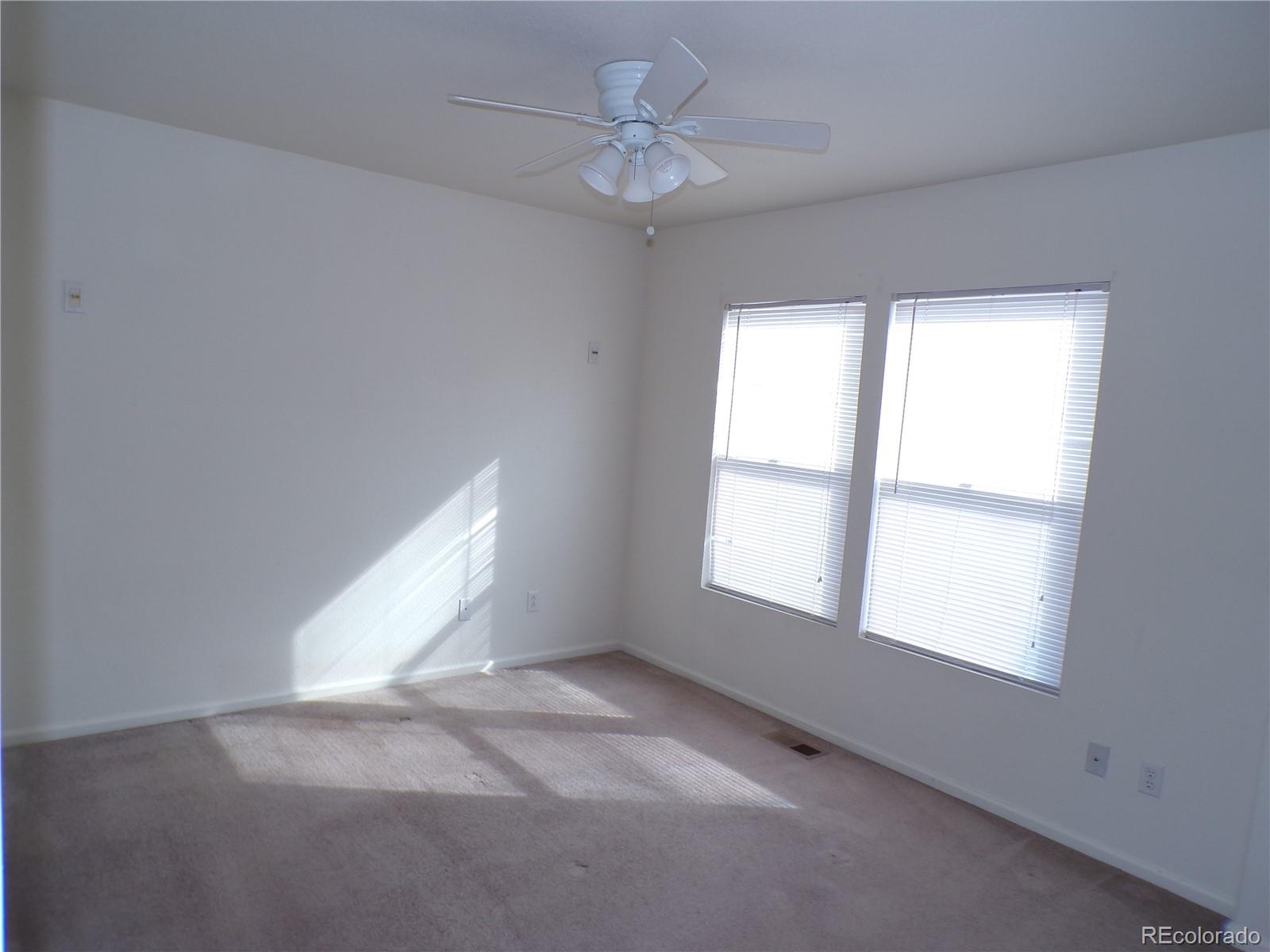 Undisclosed Address Morrison, CO 80465 - Photo 8 of 20 an empty room with chandelier fan and windows