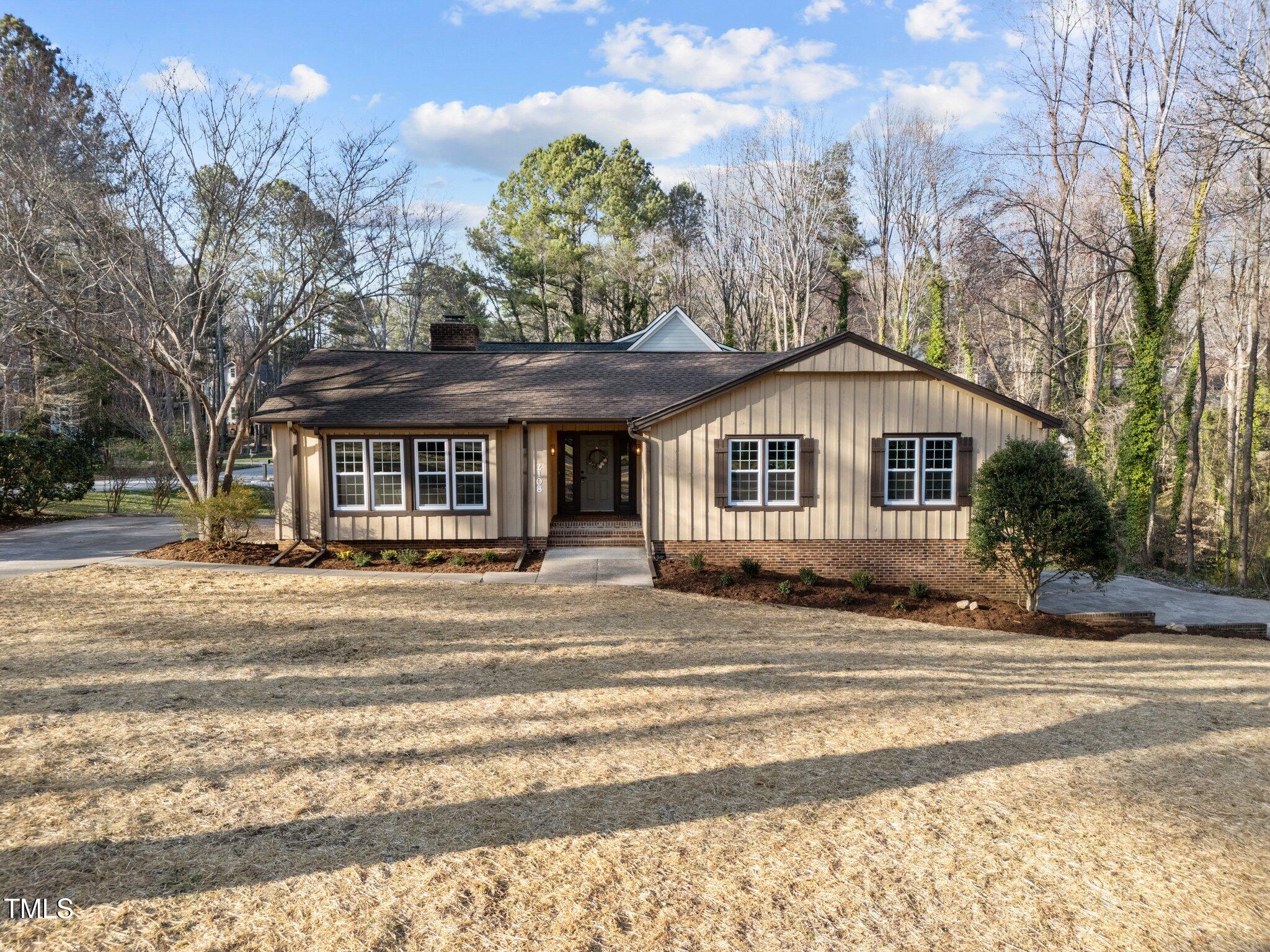 2108 Rangecrest Road Raleigh, NC 27612 - Photo 1 of 38 a front view of a house with a garden