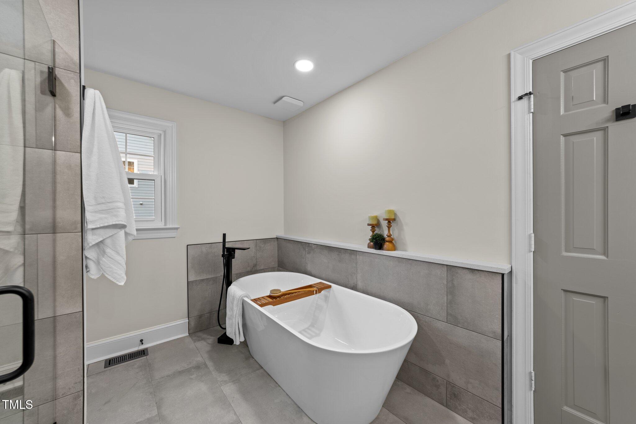 2108 Rangecrest Road Raleigh, NC 27612 - Photo 18 of 38 a spacious bathroom with a bathtub and shower
