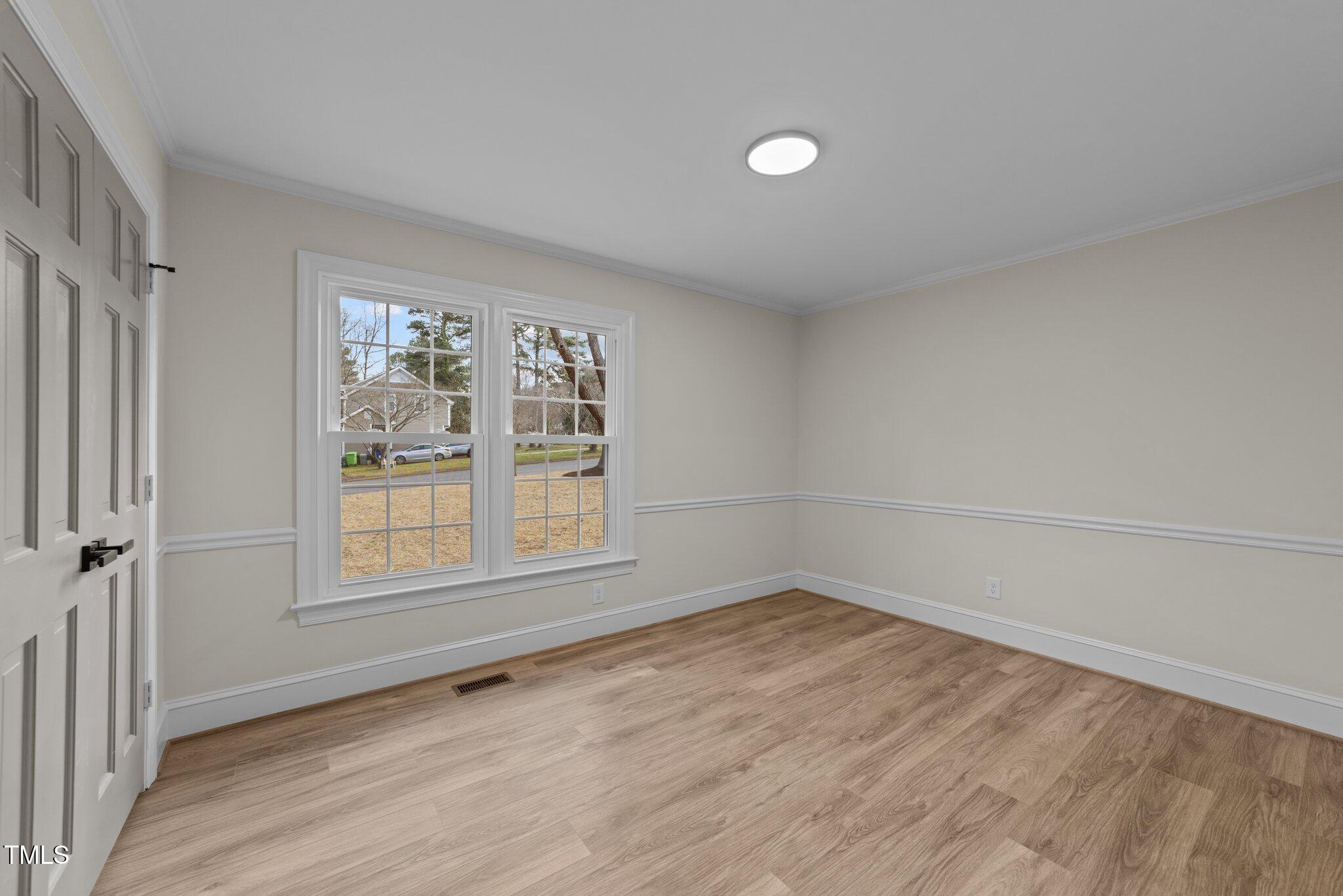 2108 Rangecrest Road Raleigh, NC 27612 - Photo 20 of 38 an empty room with wooden floor and windows
