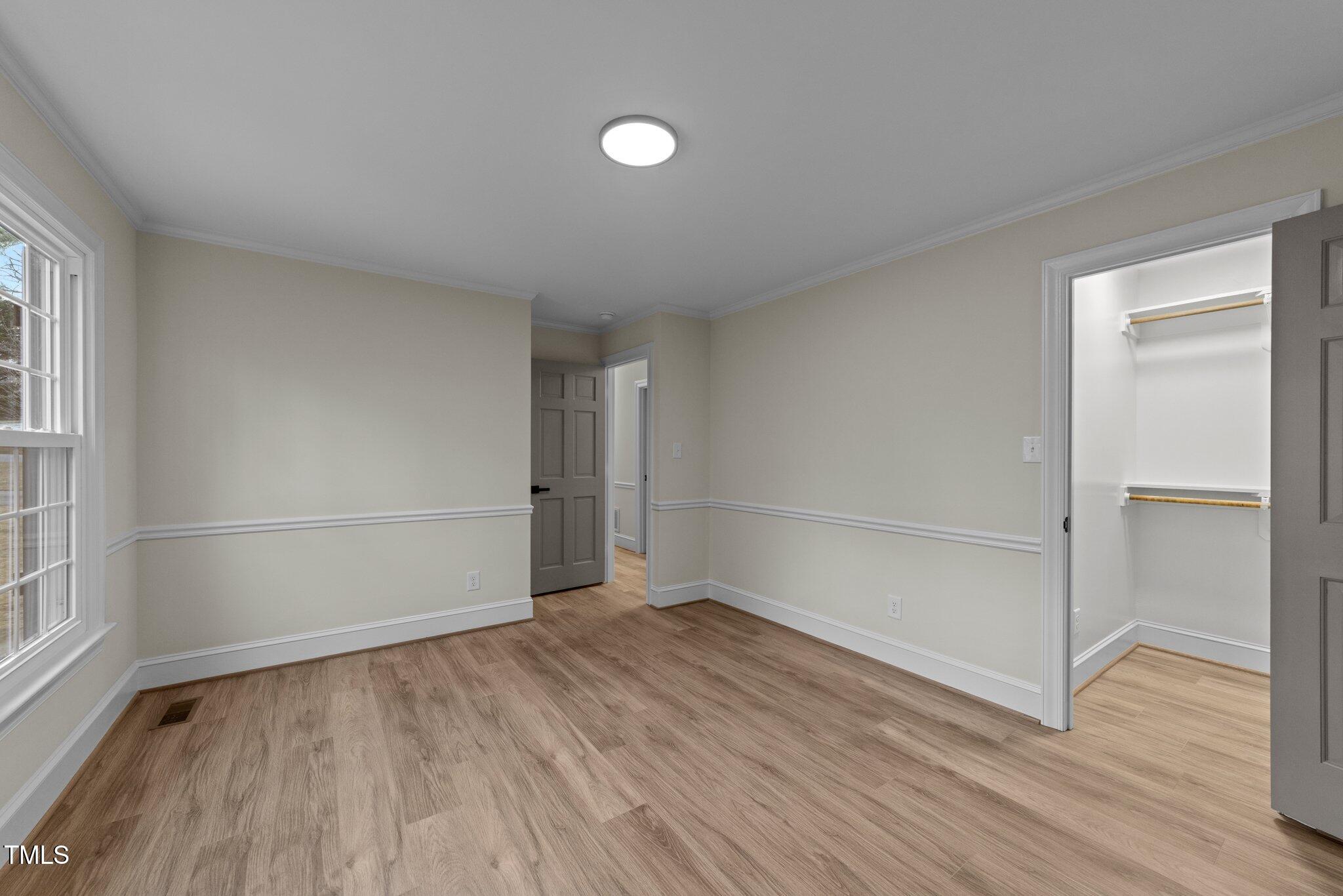 2108 Rangecrest Road Raleigh, NC 27612 - Photo 24 of 38 an empty room with wooden floor and windows