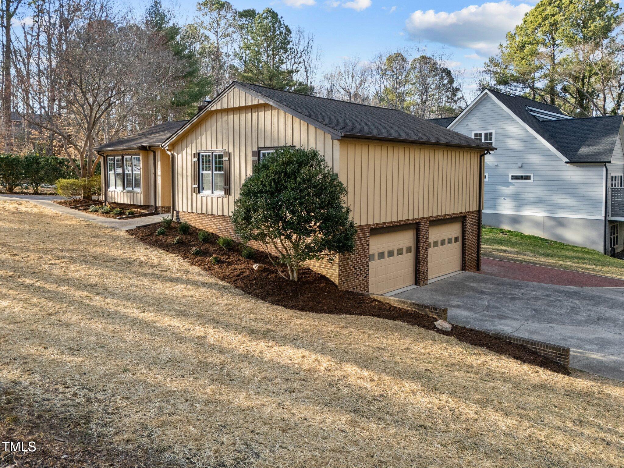 2108 Rangecrest Road Raleigh, NC 27612 - Photo 34 of 38 a front view of a house with a yard and garage